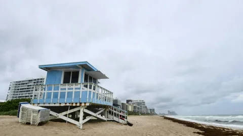 Wide angle view time-lapse of lifeguard house under fast stormy clouds Stock Footage 54242030