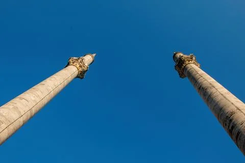 Wide angle view of two mosque minarets against a clear blue sky. 스톡 사진