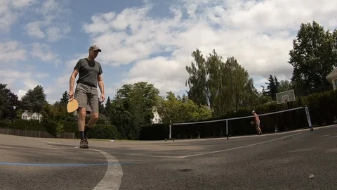 Wide angle view of two people playing pickleball. Stock Footage 120214106