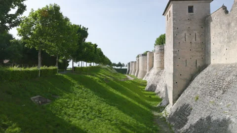 Wide angle view of a vast medieval stone fortification wall with protective towe Stock Footage 336134219