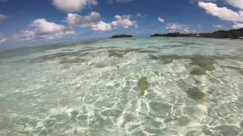 Wide angle view of waking in a crystal clear turquoise turbulence shallow lagoon Stock Footage 250400775