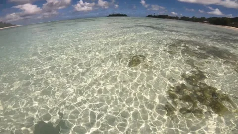 Wide angle view of waking in a crystal clear turquoise blue shallow lagoon salt  Stock Footage 250400810