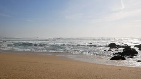 Wide angle view of white surf waves breaking on the sandy shore of the beach Stock Footage 103646276