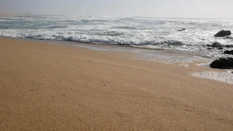 Wide angle view of white surf waves breaking on the sandy shore of the beach Stock Footage 103646304