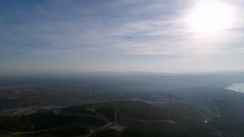 Wide angle view of wind turbines against the sun Stock Footage 121895380
