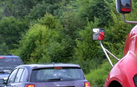 Wide angle viewing side mirror on semi-trialer truck safely covering a trucke Stock Photos