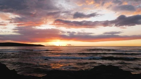 Wide angle of waves on a cliff at sunset Video stock 246389796
