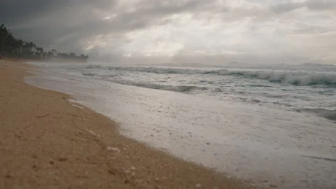 Wide Angle of Waves Lapping Against Golden Sandy Beach 4K Stock Footage 267048604