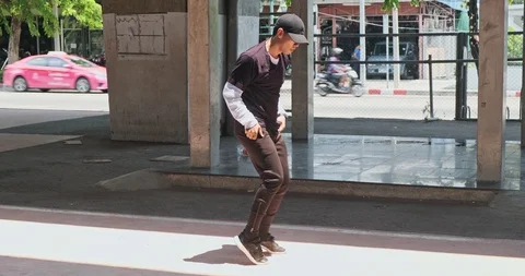 Wide angle of young man doing freestyle street dancing with skateboard park in Video stock 106377491