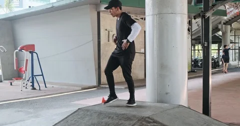 Wide angle of young man doing freestyle street dancing with basketball park in Stock Footage 106377590