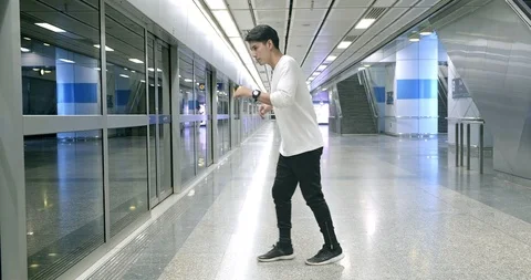 Wide angle of young man doing freestyle street dancing in underground station. Stock Footage 106384307