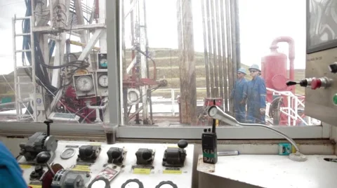 Wide Angle to Zoom In Shot of two oil and gas workers Stock Footage 45236662