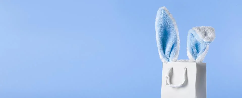 Wide banner on a blue background. The concept of online shopping for Easter. Stock Photos