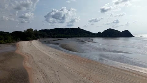 Wide beach curves gently toward sea and hills Stock-Footage 337723806