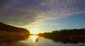 Wide beautiful river at sunset, tourists paddling boat. Slowmo HD Footage