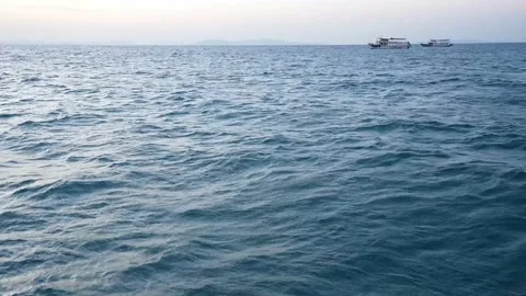 Wide blue ocean, ripple wave with travel boats Stock Footage 235583596