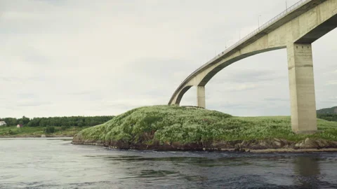 Wide Bridge Arcing Over Verdant Island with Calm Waters Below Stock-Footage 336793430