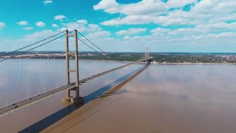 Wide bridge spans muddy river under bright sky Stock-Footage 343543137