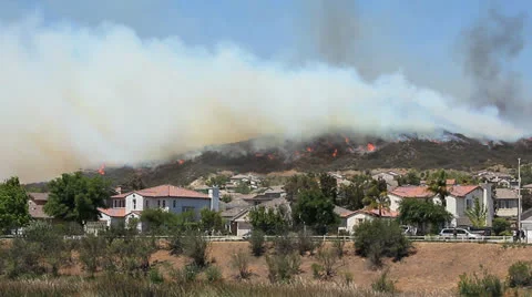 WIDE BRUSH FIRE RACES TOWARD HOMES Stock Footage 22997682