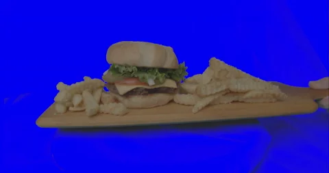 Wide Burger Set Down on Blue Screen Stock Footage 137513472