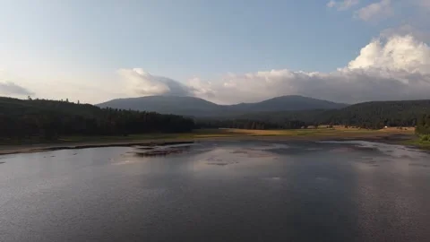 Wide calm lake surface reflecting the sky Stock Footage 340470316