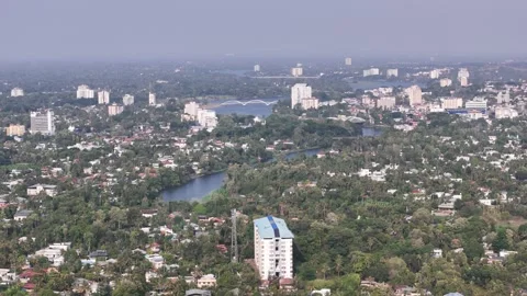 Wide cinematic aerial of Kalamassery featuring residential developments, lush Stock Footage 337911253