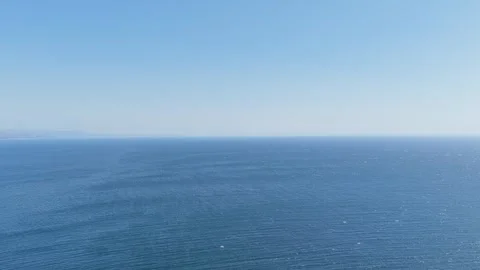 Wide, clear daytime view over the Atlantic Ocean from the coast near Faro de Stock Footage 346715701