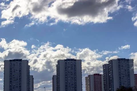 Wide clear shoot of array of concrete buildings with blue sky background Stock Photos