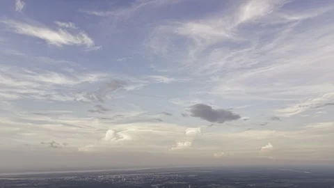 Wide Cloud-Filled Sky Above Distant Town and Farmland Stock Footage 344270555