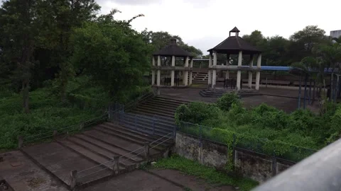 Wide concrete steps leading from a riverside cremation ghat up to traditional ri Video stock 342477394