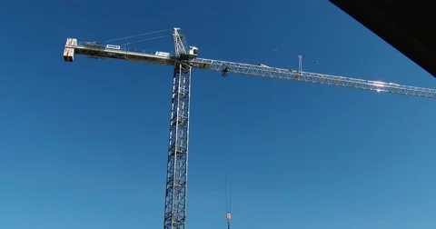 Wide of Construction Crane Moving Material - 4k Stock Footage 56259146