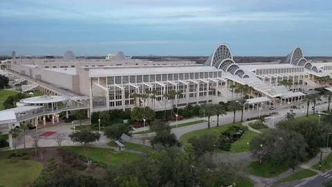 Wide convention center facade and landscaped plaza in Orlando, Florida Stock-Footage 99779334