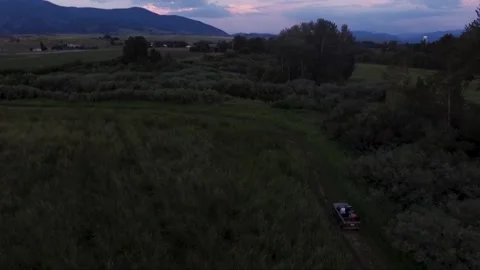 Wide of convertible driving down dirt road Stock Footage 160813419