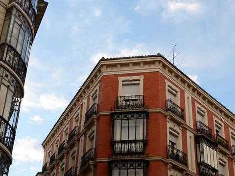 Wide corner of elegant classical building made of red brick with classy met.. Stock Photos