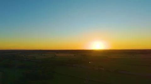 Wide countryside sunset with dramatic golden sky and agricultural mosaic. Rural Stock Footage 340195598