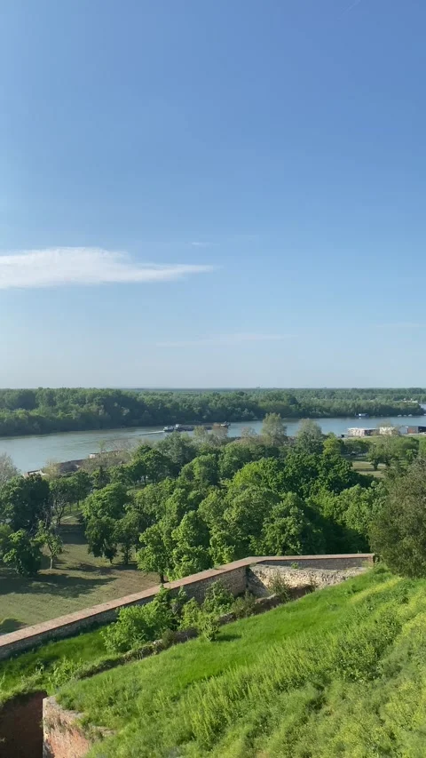 Wide Danube river flowing past distant Belgrade cityscape elevated view Stock Footage 335765598