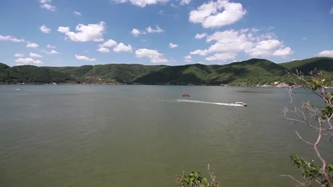  Wide Danube River Surrounded by Green Hills Under a Blue Sky Stock Footage 304917799