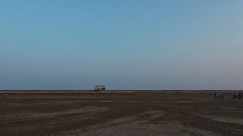 Wide Desert Landscape with Small Bus - Early Morning in Kutch Desert, Gujarat Stock Footage 287747089