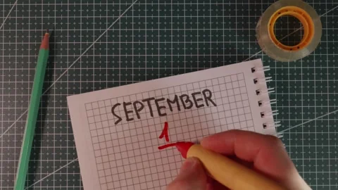 Wide detail shot of hand adding date 1 to September Stock Footage 341269449