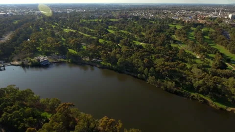 Wide drone looking over golf course and city fringe suburbs Australia 4K Stock Footage 280226719