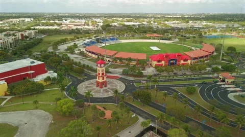 Wide Drone Orbit Around Red And Beige Clock Tower Near Lauderhill Stock Footage 339063998