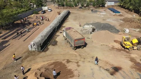 Wide Drone Perspective of Dump Truck Dumping Material at Development Site. Vidéo 339097721
