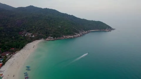 Wide drone shot of a beach with small boats and blue clear water in Koh Phangan Stock Footage 277406034