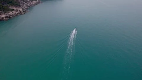Wide drone shot of a beach with small boats and blue clear water in Koh Phangan Stock Footage 277406052