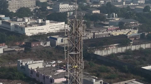 Wide Drone Shot of Communication Tower in Developing Industrial Zone with Video stock 333958900