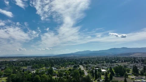 Wide drone shot of expansive Spokane neighborhoods with a bright blue sky Stock Footage 201104309