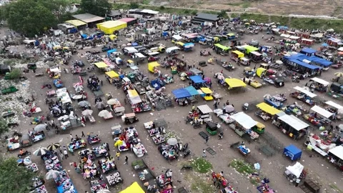 Wide Drone Shot of Large Open Air Marketplace with Goods Spread on Ground Stock Footage 346248888