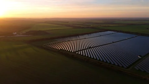 Wide drone shot of a massive renewable energy farm at sunset near Newmarket UK Stock Footage 330842261