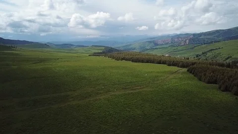 Wide drone shot of Mountain ranges and Fields 스톡 동영상 101708975