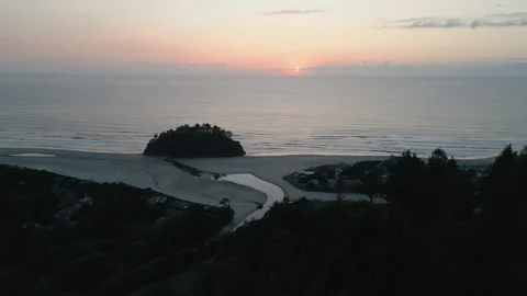 Wide drone shot of Proposal rock/ocean at Neskowin beach durring sunset Stock Footage 249028285